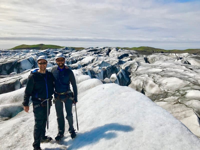 Two men standing on a glacial ice